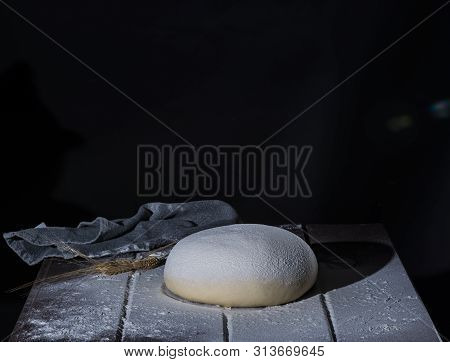 Risen  Yeast Dough For Bread Or Pizza On A Floured Surface, 45 Angle Shoot With Hard Light Selective