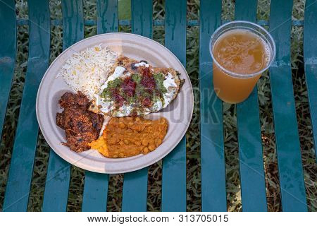 Mediterranean Meal On White Paper Plate On Park Bench Accompanied With A Glass Of Refreshing Beer Vi