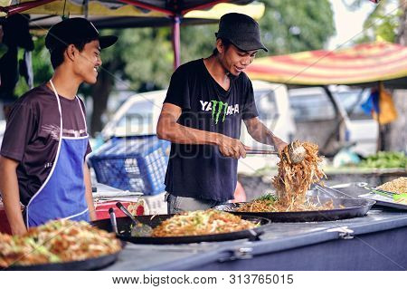 Langkawi, Malaysia - Jul, 2019: Asians Man Cooking Streetfood. Unidentified Asian People Sell Food A