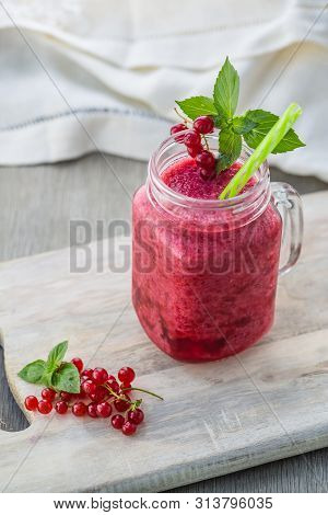 Photo Of Red Currant Smoothie In Jar With Straw On Light Background. Fresh Organic Smoothie. Health 