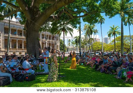 Honolulu, Hawaii - May 4,  2019:    Historic Center, an orchestra with singers plays traditional songs in the garden of the Royal Iolani Palace