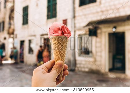 Closeup Of Girl Or Woman Holding Ice Cream Of Trend Living Coral Color In Waffle Cup On The Backgrou