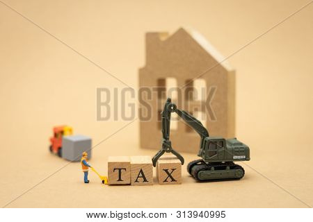 Miniature People Construction Worker Standing With Wood Word Tax Using As Background Business Concep