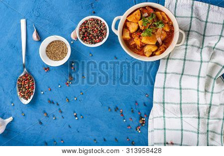Close Up Of Saltwort With Meat, Potatoes, Tomato Sauce And Mushrooms In A Bowl On A Stone Blue Backg