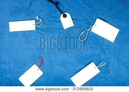 Many Price Tags On A Blue Stone Background. Mockup