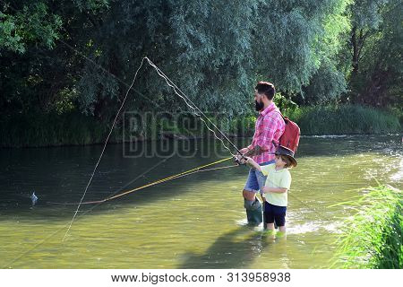 Happy Man Family Concept - Fishing And Have Fun Together. Generations Ages: Father And Son. Fishing 
