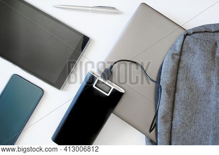 Smartphone, Tablet And External Battery - Power Bank Next To Gray Textile Backpack, Which Contains L
