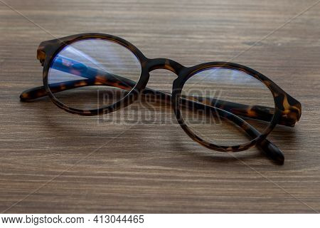 Eye Glasses On The Wooden Office Table