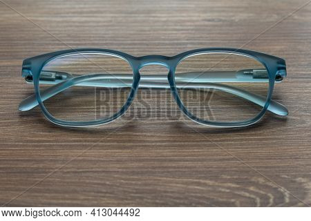Eyeglassed Blue Color On Wooden Table Office