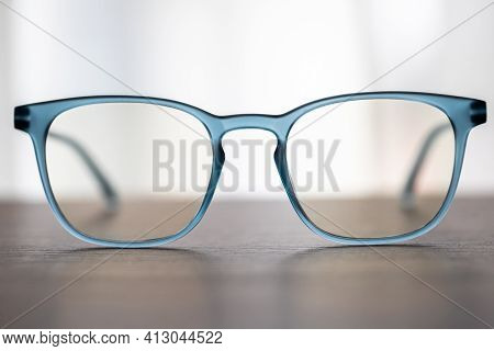 Eyeglassed Blue Color On Wooden Table Office