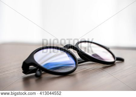 Eye Glasses On The Wooden Office Table