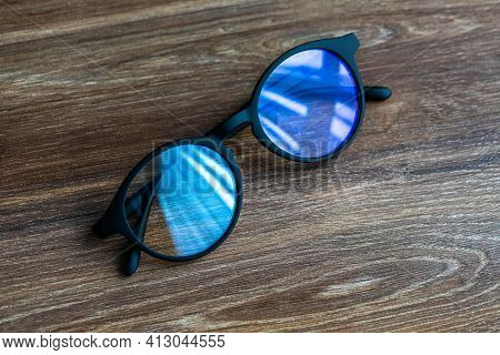 Eye Glasses On The Wooden Office Table