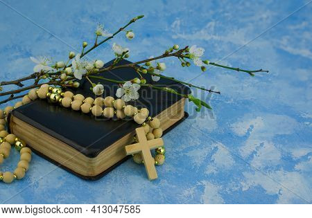 Closeup Of Wooden Christian Cross On Bible And Prayer Beads