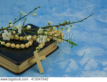 Closeup Of Wooden Christian Cross On Bible And Prayer Beads