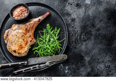 Bbq Grilled Tomahawk Pork Chop Meat Steak On A Marble Board. Black Background. Top View. Copy Space