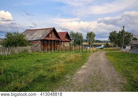 Village Street In Summer. Old Wooden House With Barn. Ancient Village Of Visim, Sverdlovsk Region, U