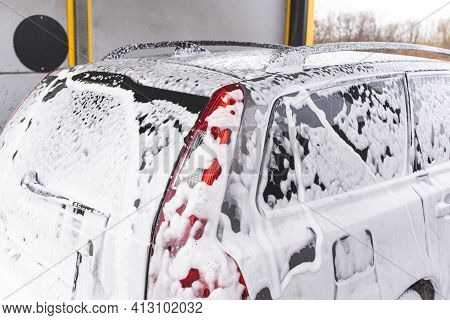Car Covered With Washing Foam At Contactless Car Washing Service