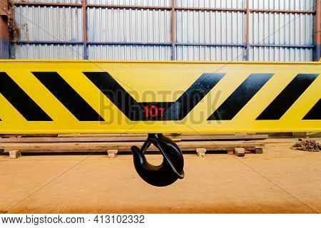 Crane Hook On A Yellow Metal Girder. Carrying Capacity Ten Tons. Lifting A Load Weighing Ten Tons. L