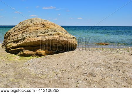 Sea Wave Breaks On Beach Rocks Landscape. Bright Summer Sunny Day. The Stone Lies On The Beach. Larg