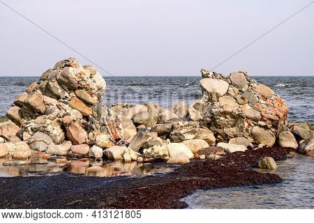 Large Stone Boulders Of The Breakwater On The Shore Of The Gulf Of Riga At Cape Kolka On A Summer Da