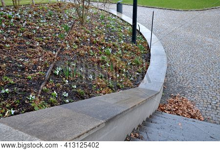 Retaining Wall At The Large Staircase In The Park The Flowerbed Area Is Planted With Rich Greenery O