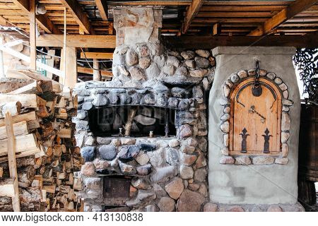 Old Slavic Village Street Cooking Stove With Stack Of Firewood Nearby