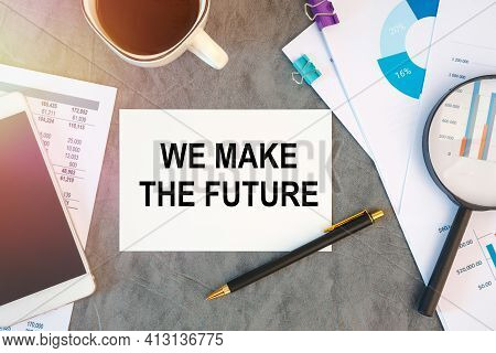 We Make The Future Is Written In A Document On The Office Desk With Office Accessories, Coffee, Diag