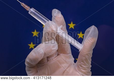 Hand With A Syringe And Emblem Of The European Union In The Background.