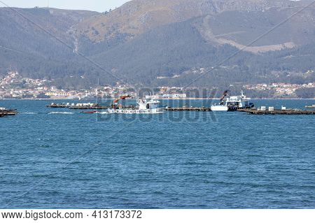 Mussel Boat Sailing Between Mussel Wood Platform Called Batea. Marine Landscape. Rias Baixas, Galici