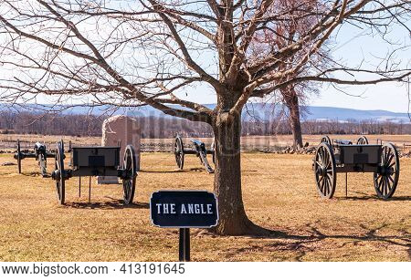 Wooden Caissons, Cannons And A Stone Monument At The Angle With A Sign Below A Tree On The Gettysbur