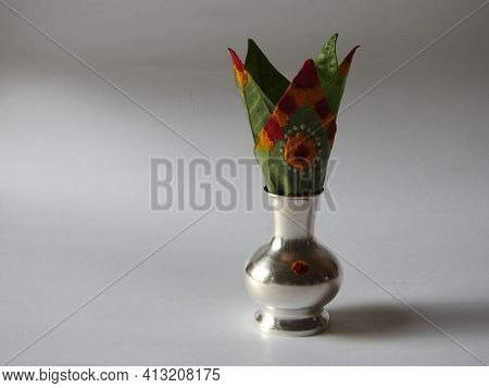 Closeup Of Silver Kalash Decorated With Chrysanthemum Flower, Leaf, Coconut, Kumkum And Turmeric Wit