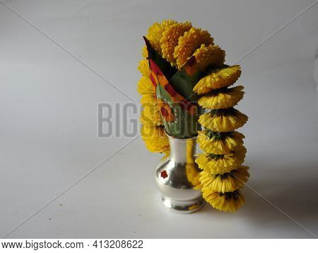 Closeup Of Silver Kalash Decorated With Chrysanthemum Flower, Leaf, Coconut, Kumkum And Turmeric Wit