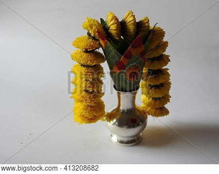 Closeup Of Silver Kalash Decorated With Chrysanthemum Flower, Leaf, Coconut, Kumkum And Turmeric Wit
