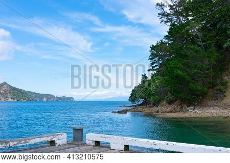 Wharf And Harbour At Okupu Bay On Great Barrier Island New Zealand.