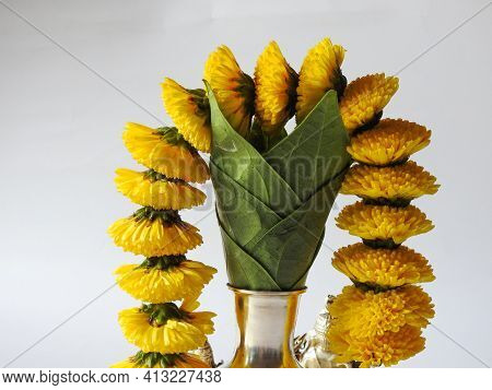 Closeup Of Silver Kalash Decorated With Chrysanthemum Flower, Leaf, Coconut, Kumkum And Turmeric Wit