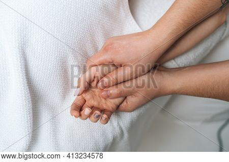 Close-up Of Male Masseur Doing Finger And Palm Massage To Woman Lying On Massage Table In Spa Salon.