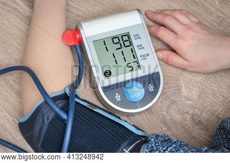 Blood Pressure Monitor With High Pressure Level On Screen - Hypertension Concept