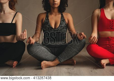 Fit Athletic Women Doing Yoga, Self Control. Beautiful Women Working Out In Gym Together. Intense Fi