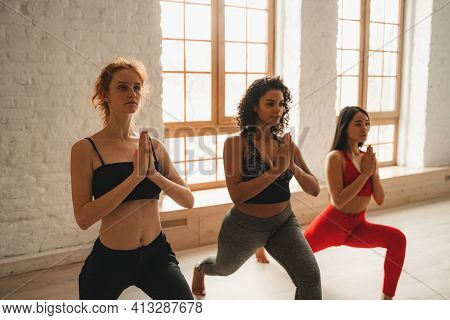 Fit Athletic Women Doing Yoga, Healthy Lifestyle. Beautiful Women Working Out In Gym Together. Inten