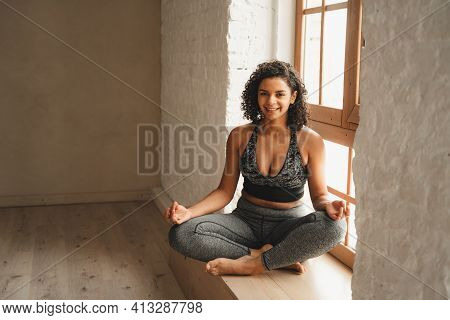 Fit Athletic Woman Doing Meditation, Self Control. Beautiful Women Working Out In Gym Together. Inte