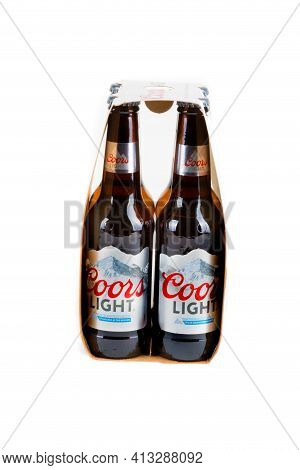 Sandhurst, United Kingdom, 18th March 2021:- Four Bottles Of Coors Light Isoalted On A White Backgro