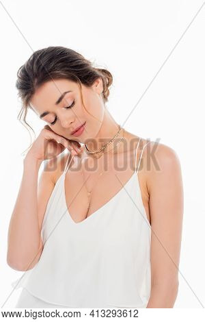 Charming Fiancee Holding Hand Near Face While Posing With Closed Eyes Isolated On White.