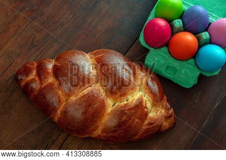 Easter Eggs And Tsoureki Braid, Greek Easter Sweet Bread, On Wooden Background