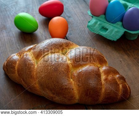 Easter Eggs And Tsoureki Braid, Greek Easter Sweet Bread, On Wooden Background