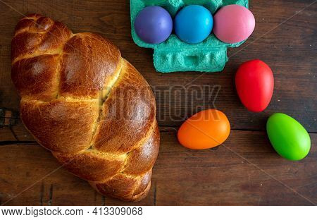 Easter Eggs And Tsoureki Braid, Greek Easter Sweet Bread, On Wooden Background