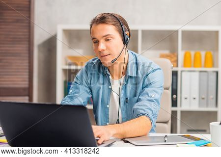 Workplace Of Freelance Worker Or Sudent At Home Office. Young Man Works Using Computer And Other Dev