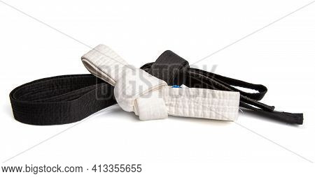 Black Belt Top Skill And White Entry Level Martial Arts Tied In A Knot And Isolated On White Backgro