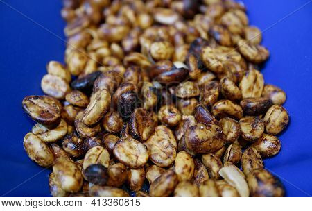 Closeup Of Heap Of Yellow Honey Process Coffee Beans