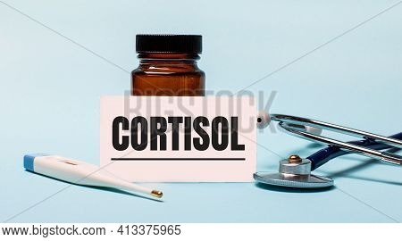 On A Blue Background - A Bottle For Pills, A Stethoscope, An Electronic Thermometer And A Card With 
