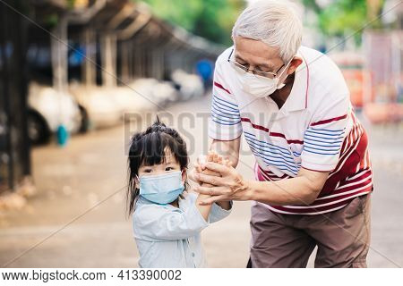 Happy Family Wear Face Mask. Grandfather Taught Grandchildren To Rub His Hands, Wash His Hands With 
